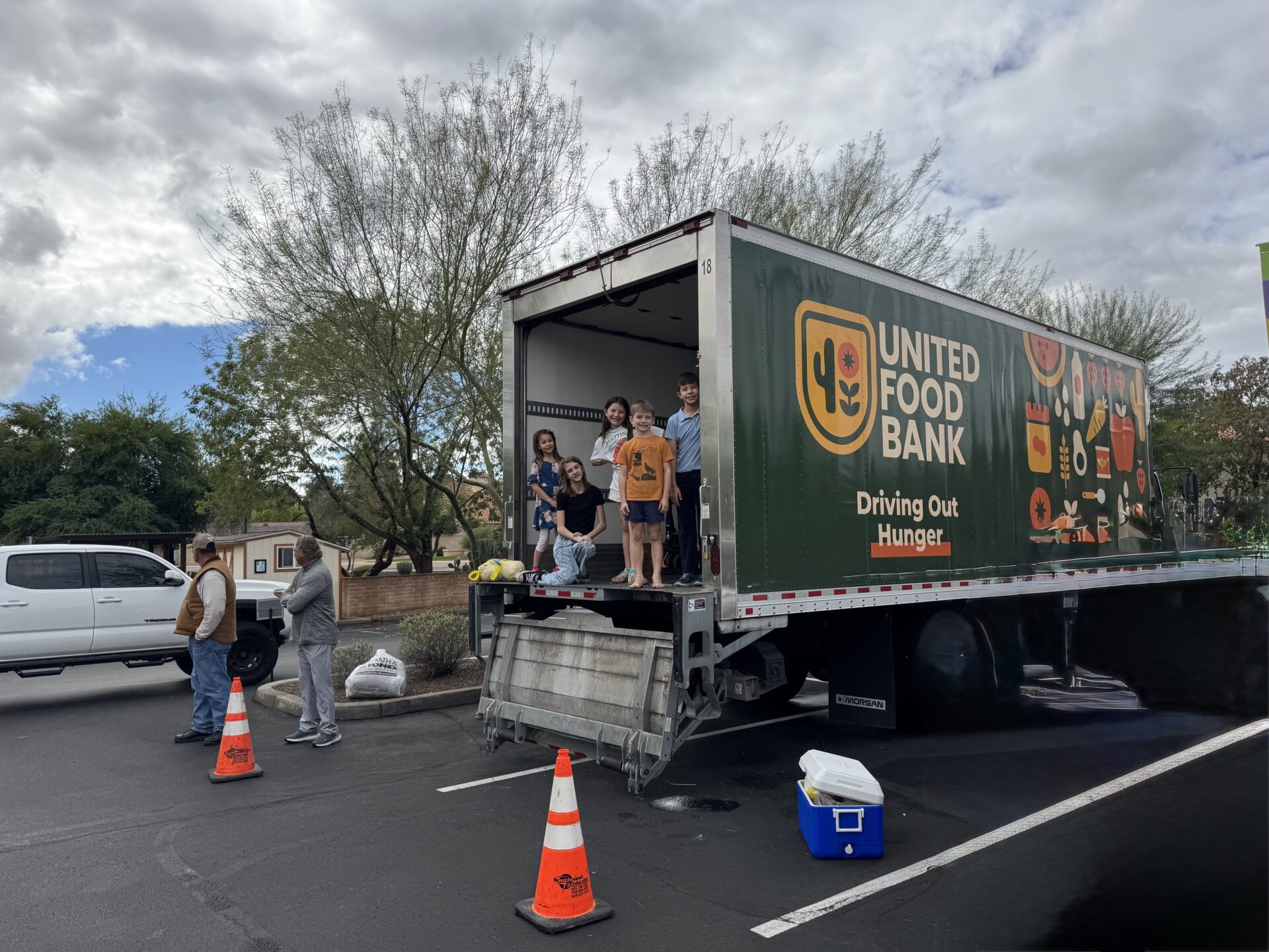 Kids standing in a food bank truck during a service project