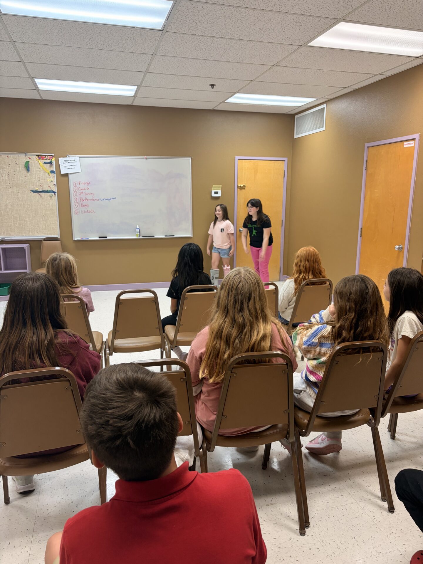 Kids presenting at the front of the room during BeTween gathering